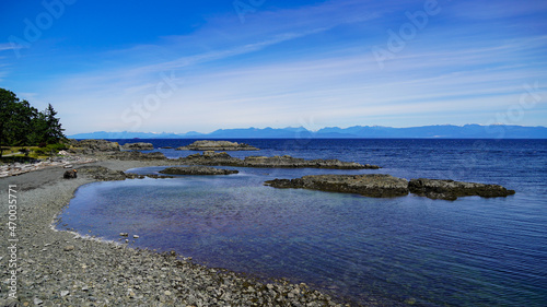 Beautiful scenic view to rocks beach, Pacific Ocean and blue sky at Neck Point on Vancouver Island