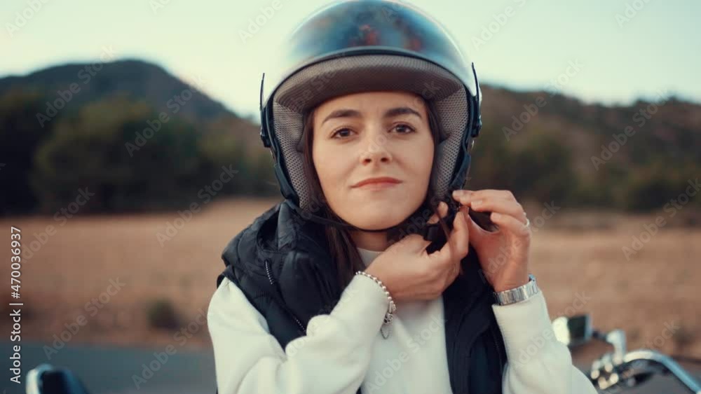 Young Woman Wears Open Face Helmet Before Riding A Motorbike. - close up Young Woman Wears Open Face Helmet Before Riding A Motorbike. - close up