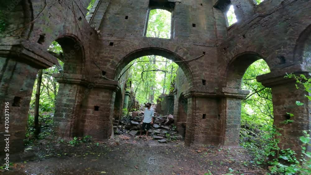 Young man exploring old ruined abandoned house in Goa, India Young man exploring old ruined abandoned house in Goa, India