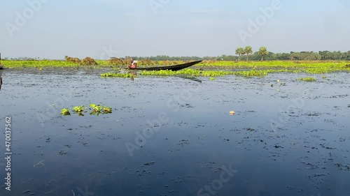 Aerial view of boatmen sitting in the boat and preparing for sailing the boat at bortirbil,west Bengal.A village young man is driving a wooden boat at Aerial Bortirbil, kolkata,India. photo