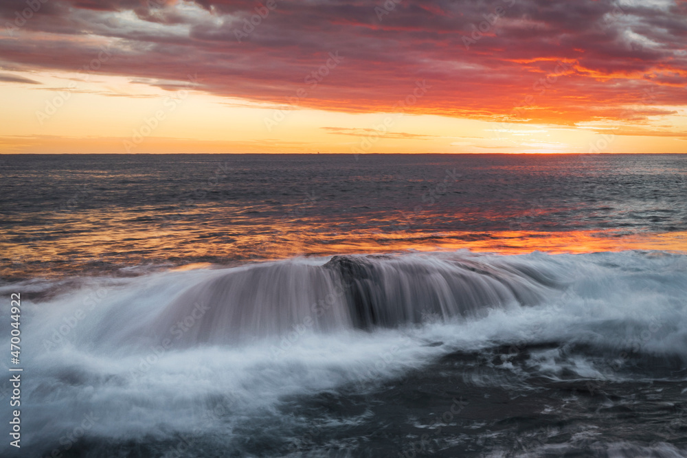 Waterfall cascades over a rock at terrigal on nsw central coast