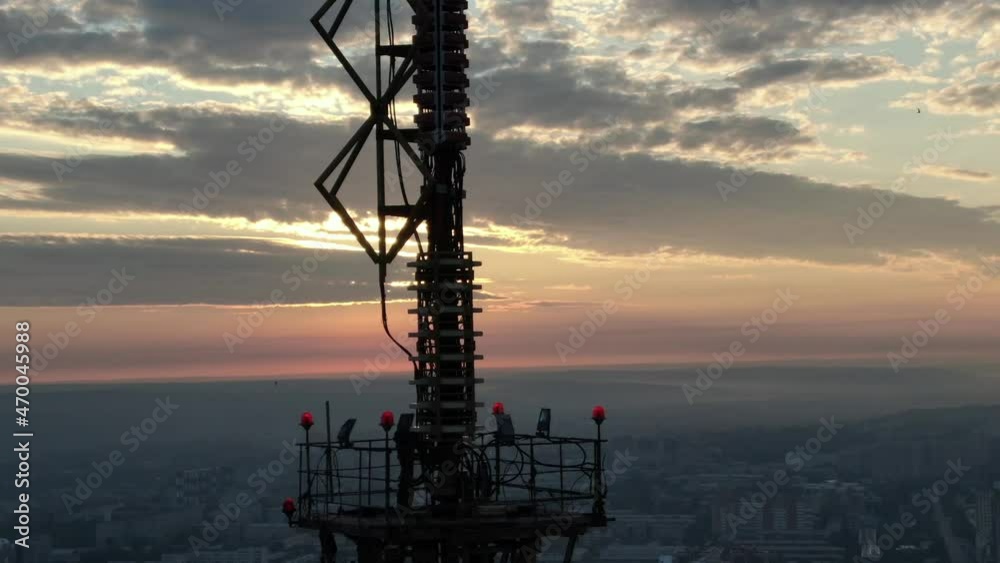 Dawn over the city of Irkutsk. The sun rises over the TV tower. Swallows fly by against the background of the rising sun. Shooting from a drone. Top view Dawn over the city of Irkutsk. The sun rises over the TV tower. Swallows fly by against the background of the rising sun. Shooting from a drone. Top view