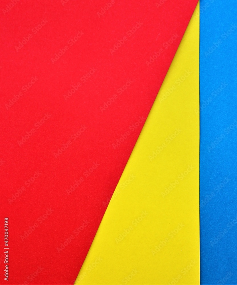Abstract red-yellow-blue background. Red, yellow and blue paper. Flag, collage.