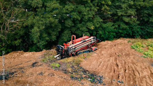 Aerial view of Drilling machine work process. Horizontal directional drilling technology. Trenchless laying of communications, pipes and water pipes. Selective focus