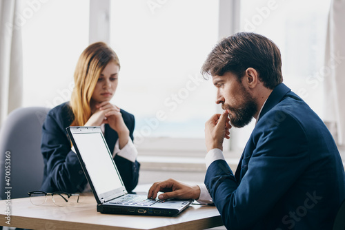 colleagues in the office in front of a laptop career network technologies