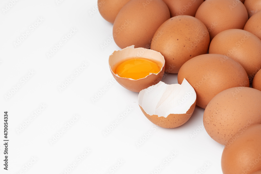 Brown raw eggs and one broken isolated on white background Brown raw eggs and one broken isolated on white background
