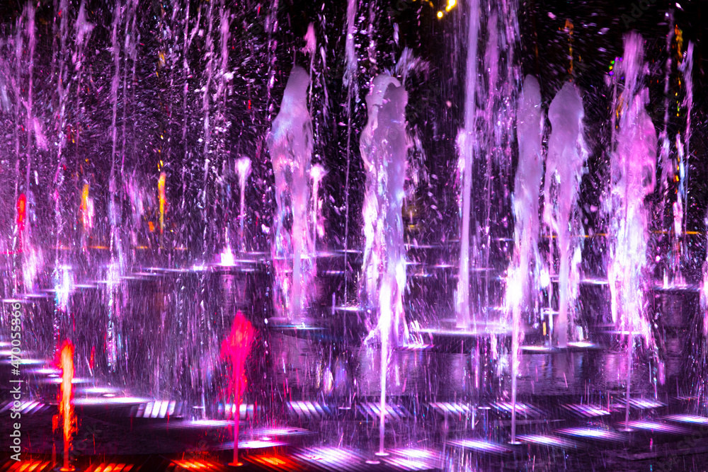 Pink jets of the fountain at night.