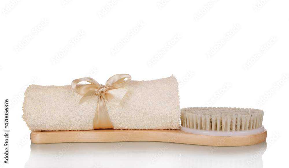 Spa set. Beige towel and soft massage body brush isolated on white Spa set. Beige towel and soft massage body brush isolated on white