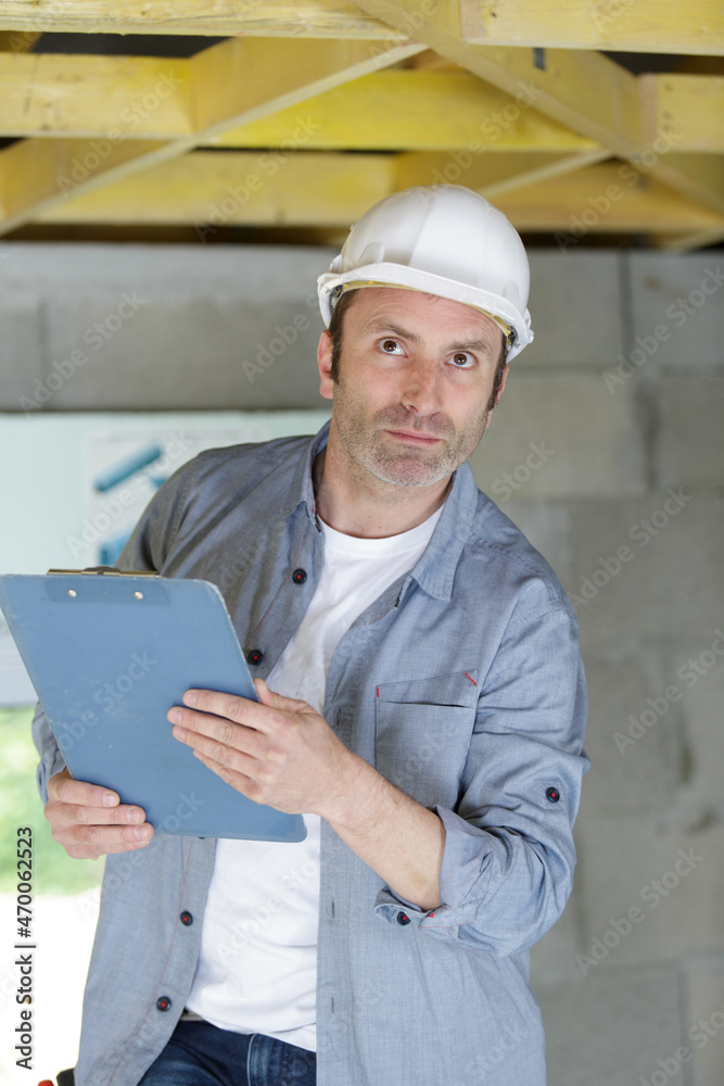 man builder checking the ceiling man builder checking the ceiling