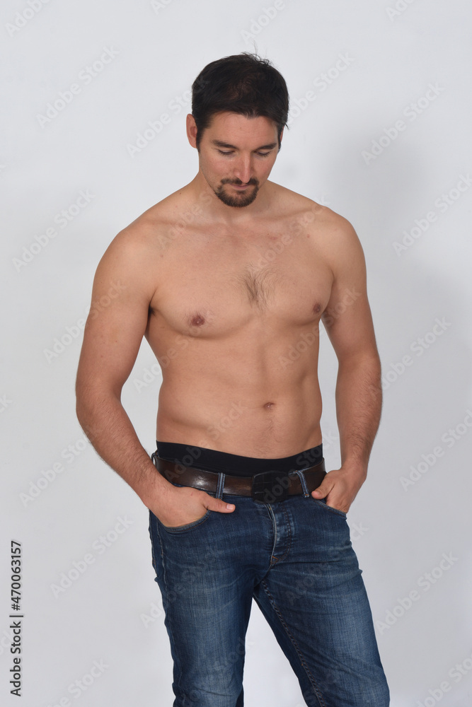 portriat of a man shirtless looking up on white background