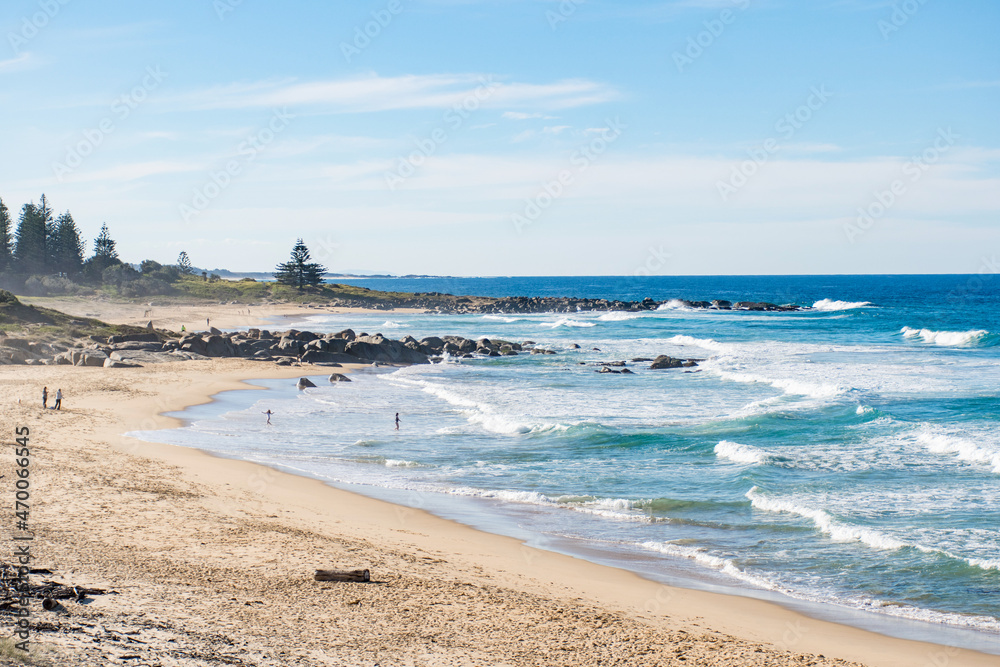 Ocean waves and sandy beach on a sunny day. Nature tropical paradise background. Tuross Head, NSW, Australia