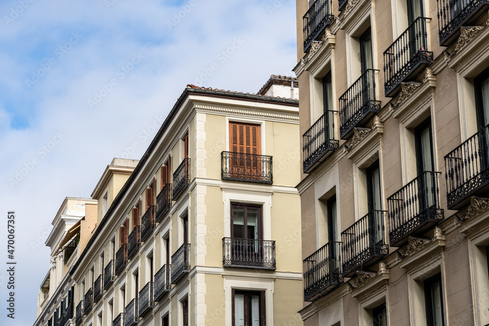 Old residential building against sky. Malasana quarter in Madrid. Real estate and architecture concepts.