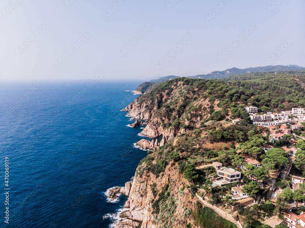 Drone view of rocky cliffs and the sea in the city of Tossa de Mar. Drone shot of a municipality in Spain. The resort town of Tossa de Mar near the Mediterranean Sea. Drone shot Tossa de Mar
