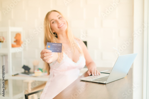 caucasian woman playing laptop with credit card