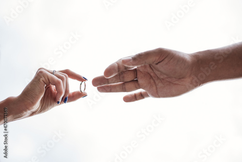 Woman is putting wedding ring on her man finger
