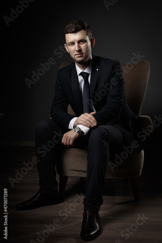 Portrait of business man in black suit, white shirt and black tie © Victoria