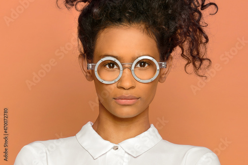 Stylish ethnic woman in round glasses