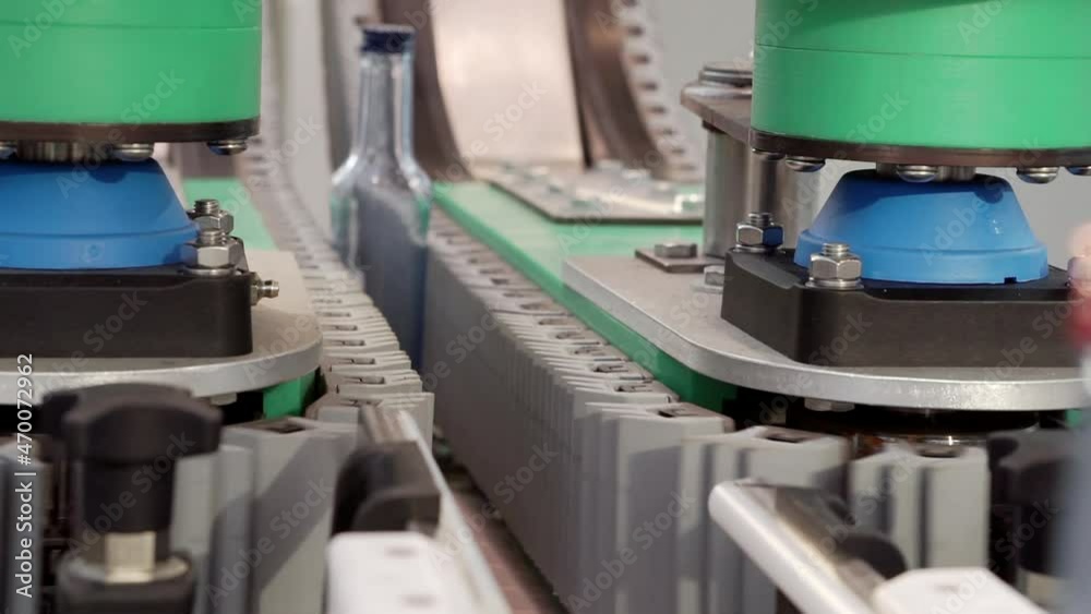 The movement of empty glass bottles on a conveyor belt. The movement of empty glass bottles on a conveyor belt.