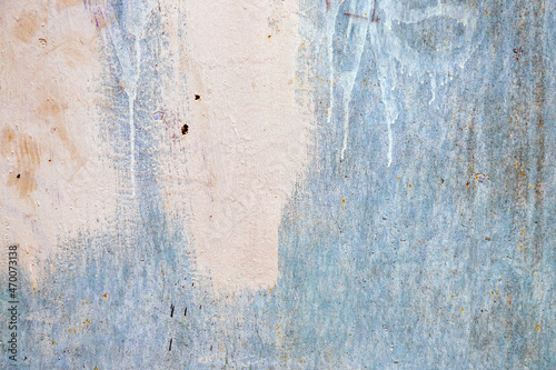 Dirty metal blue wall with traces of white paint and dirty stains with traces of rust background