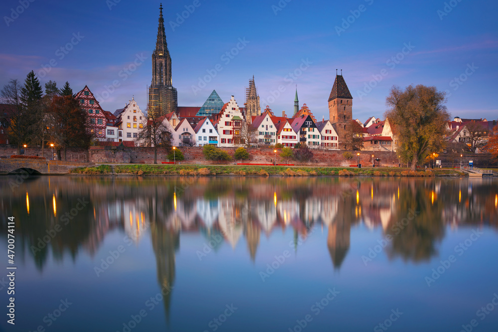 Ulm, Germany. Cityscape image of old town Ulm, Germany with the Ulm Minster, tallest church in the world and reflection of the city in Danube River at autumn sunset.