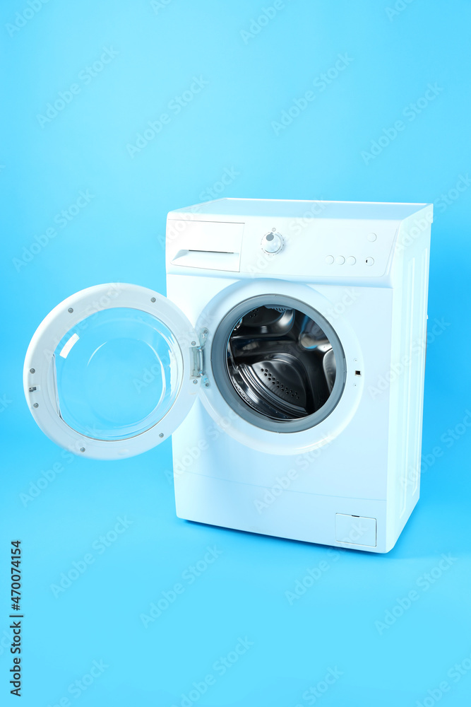 Modern white washing machine on blue background