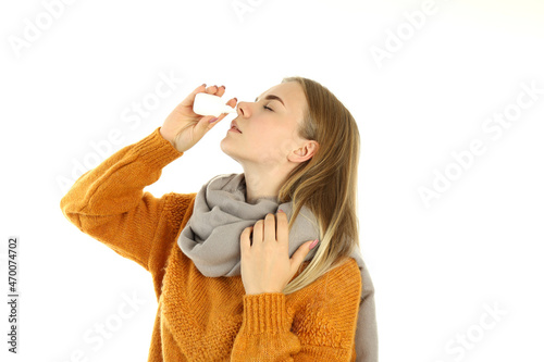Young woman with nasal spray isolated on white background
