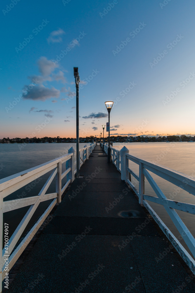 An empty jetty into the water edge at sunrise time.