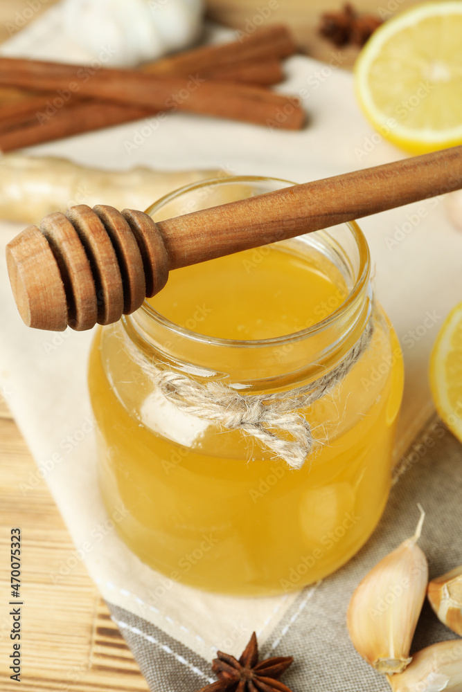 Concept of treatment colds with honey and garlic, close up Concept of treatment colds with honey and garlic, close up