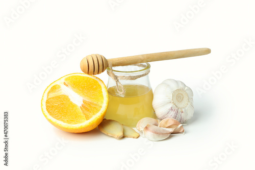 Concept of treatment colds with honey and garlic isolated on white background