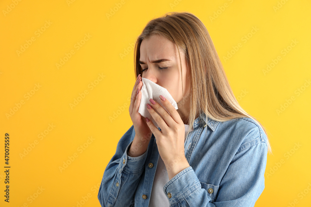 Ill young woman on yellow background, seasonal cold concept Ill young woman on yellow background, seasonal cold concept