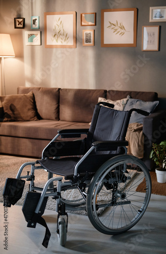 Image of empty wheelchair standing in the living room at home