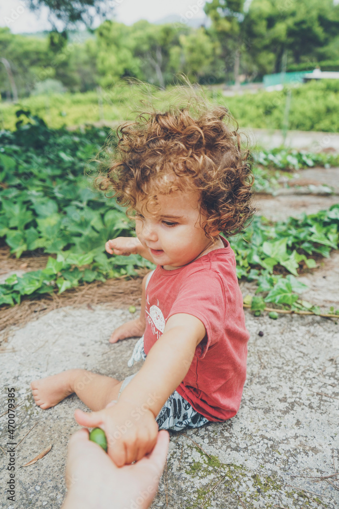 Cute toddler sit on the backyard floor Cute toddler sit on the backyard floor