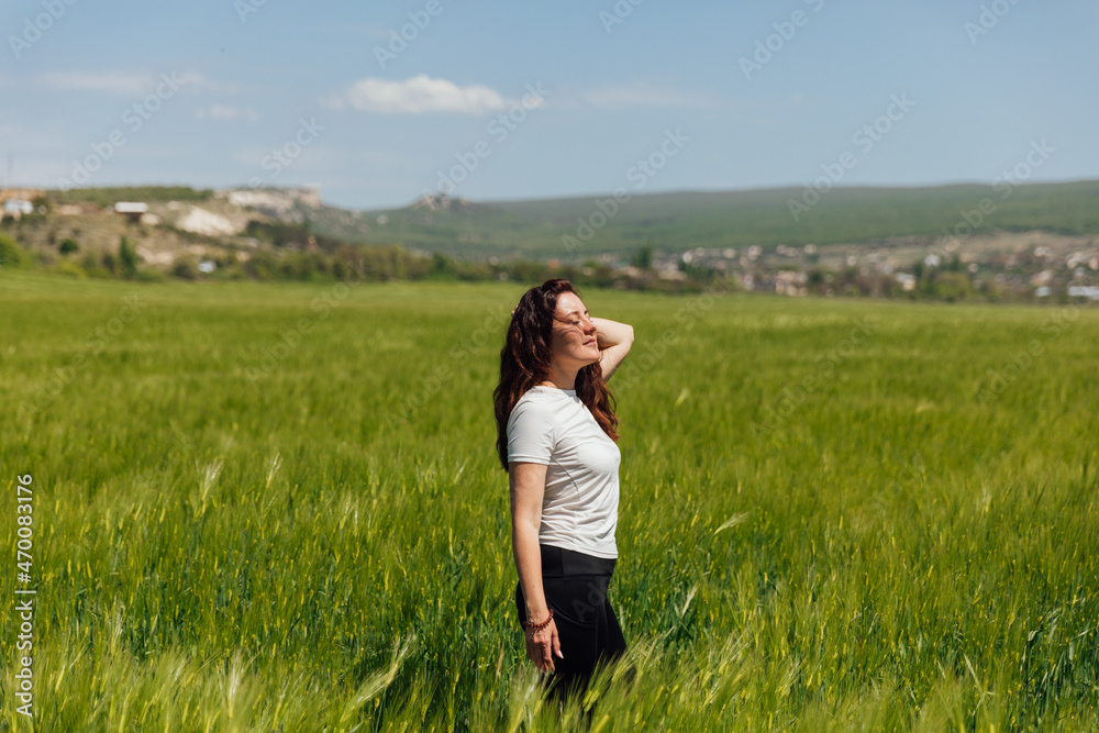 beautiful brunette woman in a field of green wheat beautiful brunette woman in a field of green wheat