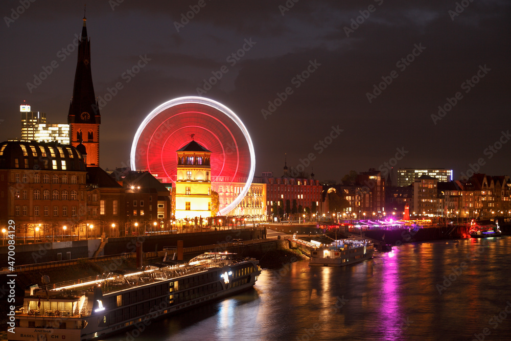 Obraz premium Rhine promenade with Castle Tower and illuminated Ferris wheel at dusk, Dusseldorf, North Rhine-Westphalia, Germany, Europe