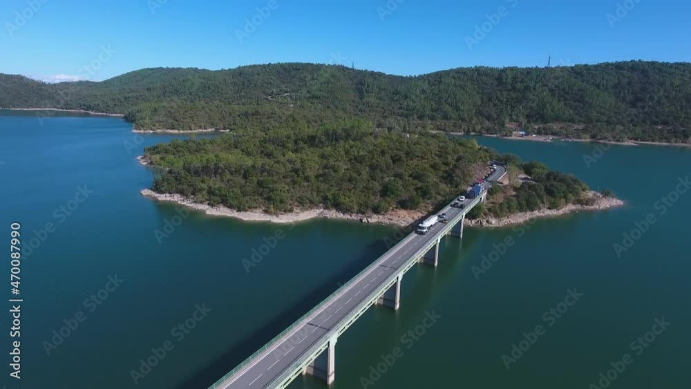 Aerial DJI of a spectacular road above a lake. Aerial DJI of a spectacular road above a lake.