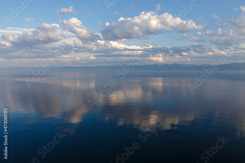 Lake Baikal in the evening. Ripples on the water surface and beautiful clouds. The clouds are reflected in the water.