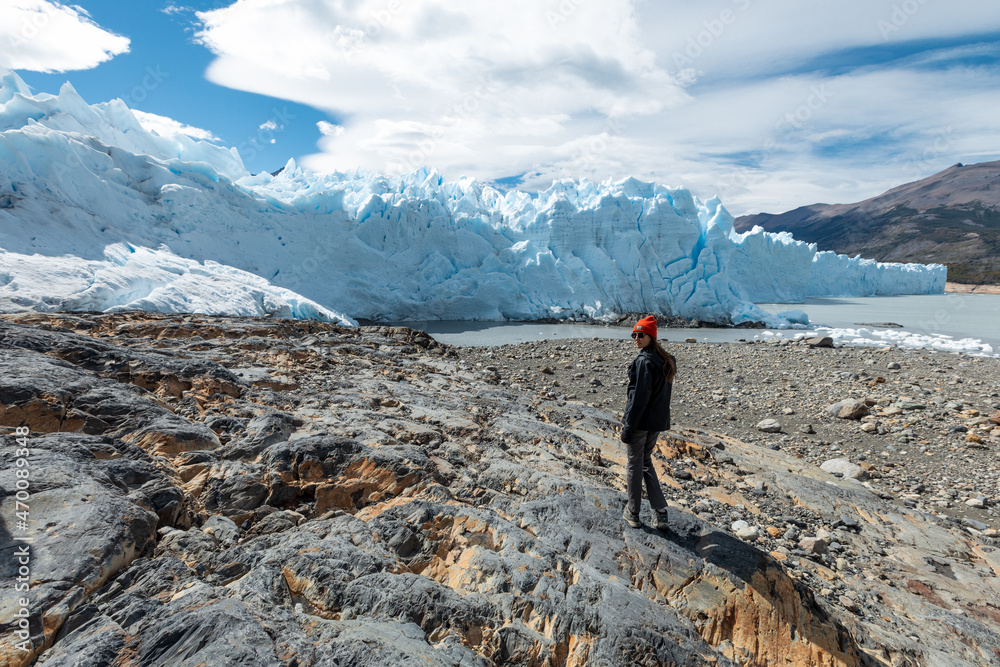 A woman posing in front of Perito Moreno Glacier