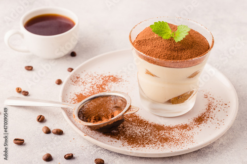 Traditional Italian dessert tiramisu in a glass.