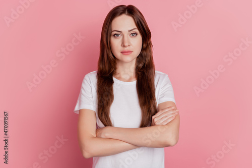 Portrait of successful confident girl crossed hands look camera on pink background