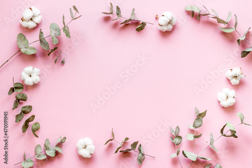 Plant branches frame with eucalyptus leaves and cotton flowers