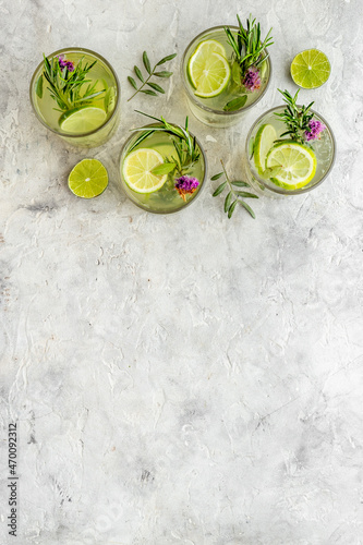 Cold fresh cocktail with summer herbs and lemon slices