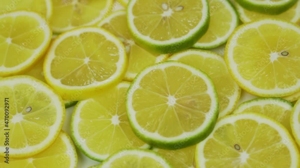 Rotating Juicy Lemon Slices. Sliced Lemons Limes, Sliced Citrus Fruit Slices with Vitamin C. Halves of Lemons. Healthy food. Rotating Juicy Lemon Slices. Sliced Lemons Limes, Sliced Citrus Fruit Slices with Vitamin C. Halves of Lemons. Healthy food.