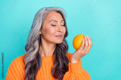 Profile side photo of mature lady aroma smell citrus eco organic calories isolated over teal color background