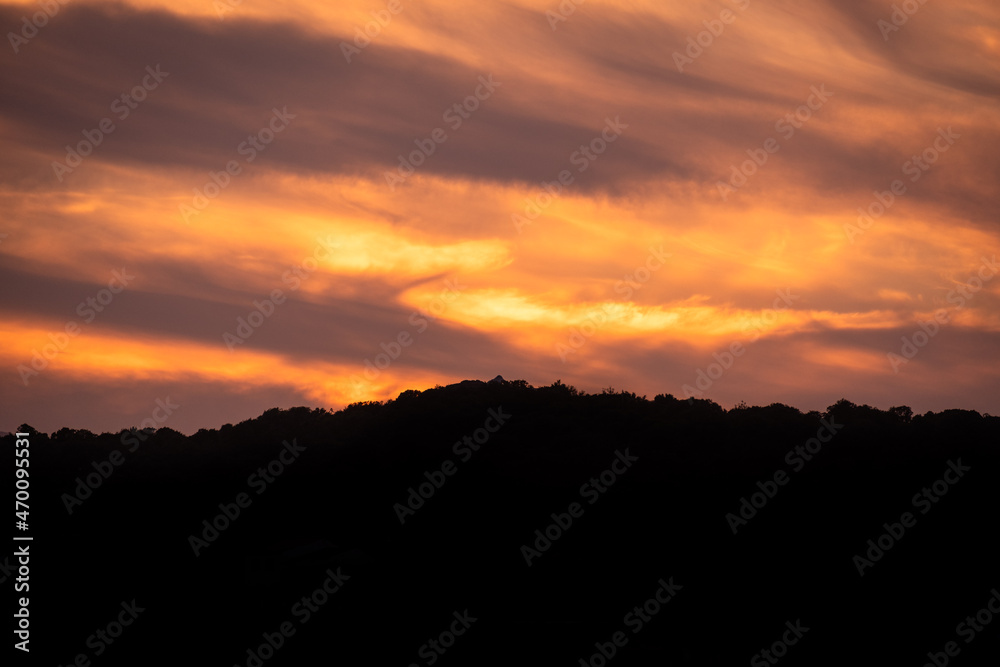 Beautiful orange sunset.  Sunset in Sardinia. Red sky over hills. Aurora effect. 