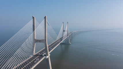 Aerial view of the most beautiful Portuguese bridge in Lisbon, Vasco da Gama. Morning foggy seascape.