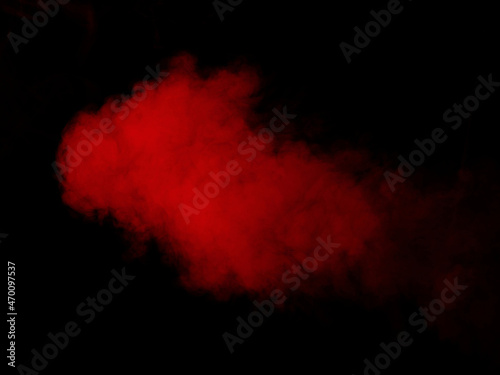 Cloud of red smoke on black background