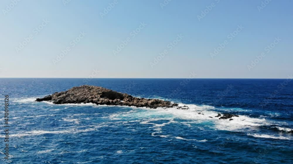 Waves Crashing Up Against The Rocks In The Middle Of The Ocean In Jerusalem Beach, Erisos, Greece - aerial drone shot Waves Crashing Up Against The Rocks In The Middle Of The Ocean In Jerusalem Beach, Erisos, Greece - aerial drone shot