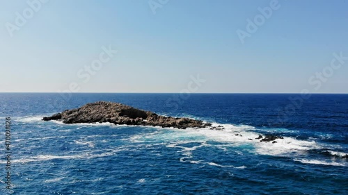 Waves Crashing Up Against The Rocks In The Middle Of The Ocean In Jerusalem Beach, Erisos, Greece - aerial drone shot photo