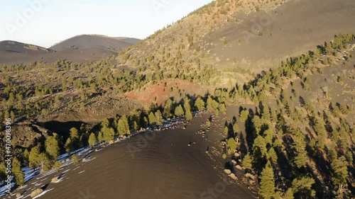 Aerial over majestic dry barren and steep ,Cinder cone volcanic lava mountain on earth. Sunset crater, Arizona. photo