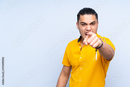 Asian handsome man over isolated background frustrated and pointing to the front